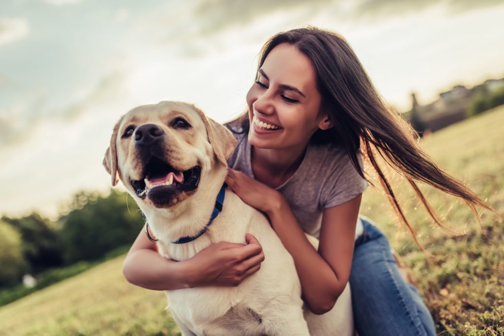 A woman embracing her dog