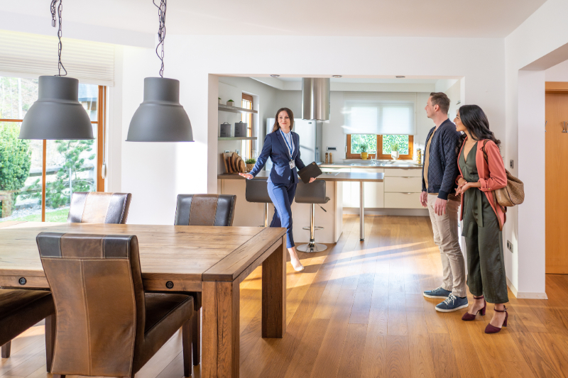 Female real estate agent showing couple apartment